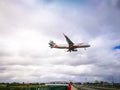 Jetstar airplane flying on cloudy sky above kingsford smith international airport.